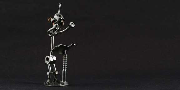 Metal figure of a composer.